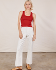 Madeline is 5'9" and wearing P Tank Top in Mustang Red paired with vintage tee off-white Western Pants