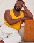 Elijah is wearing Tank Top in Sunshine Yellow