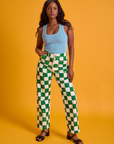 Kandia is 5'3" and wearing XS Checkerboard Work Pants in White/Green paired with a baby blue Tank Top