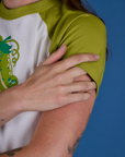 Produce Raglan Tee in Snap Peas sleeve close up on Alex