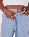 Indigo Wide Leg Trousers in Light Wash close up on Jerrod.