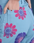 Close up of Madeline's hand in the back pocket of Floral Painted Work Pants in Blue