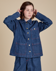 Hana is wearing a buttoned up Indigo Denim Work Jacket in Dark Wash