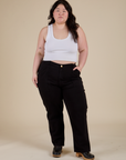 Ashley is 5’7” and wearing 1XL Work Pants in Basic Black paired with a Cropped Tank in Vintage Tee White