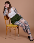 Sydney is wearing Classic Work Shorts in Evergreen and Cropped Tank in Vintage Tee White