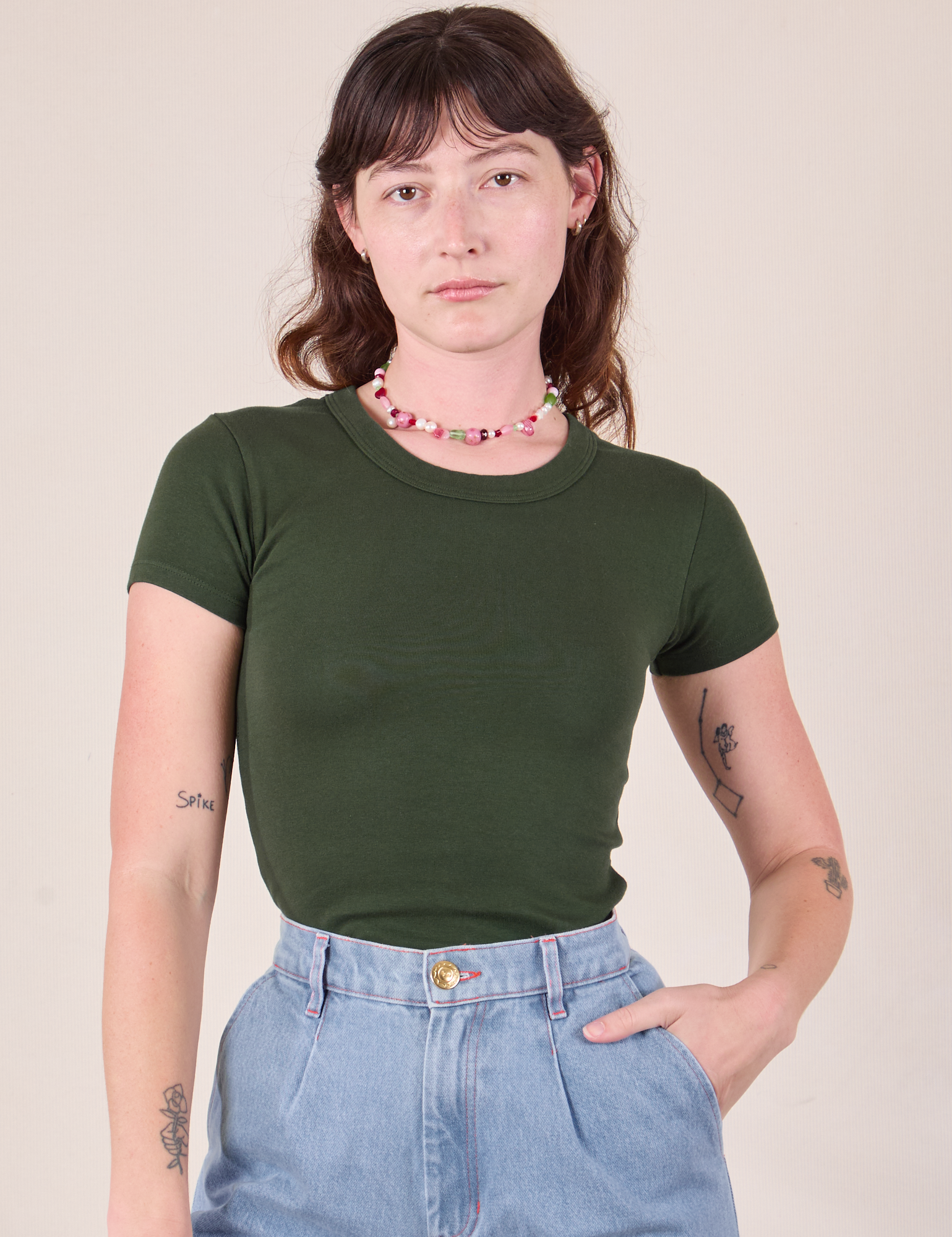 Alex is 5'8 and wearing P Baby Tee in Swamp Green