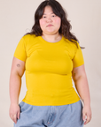 Ashley is 5'7" and wearing L Baby Tee in Golden Yellow