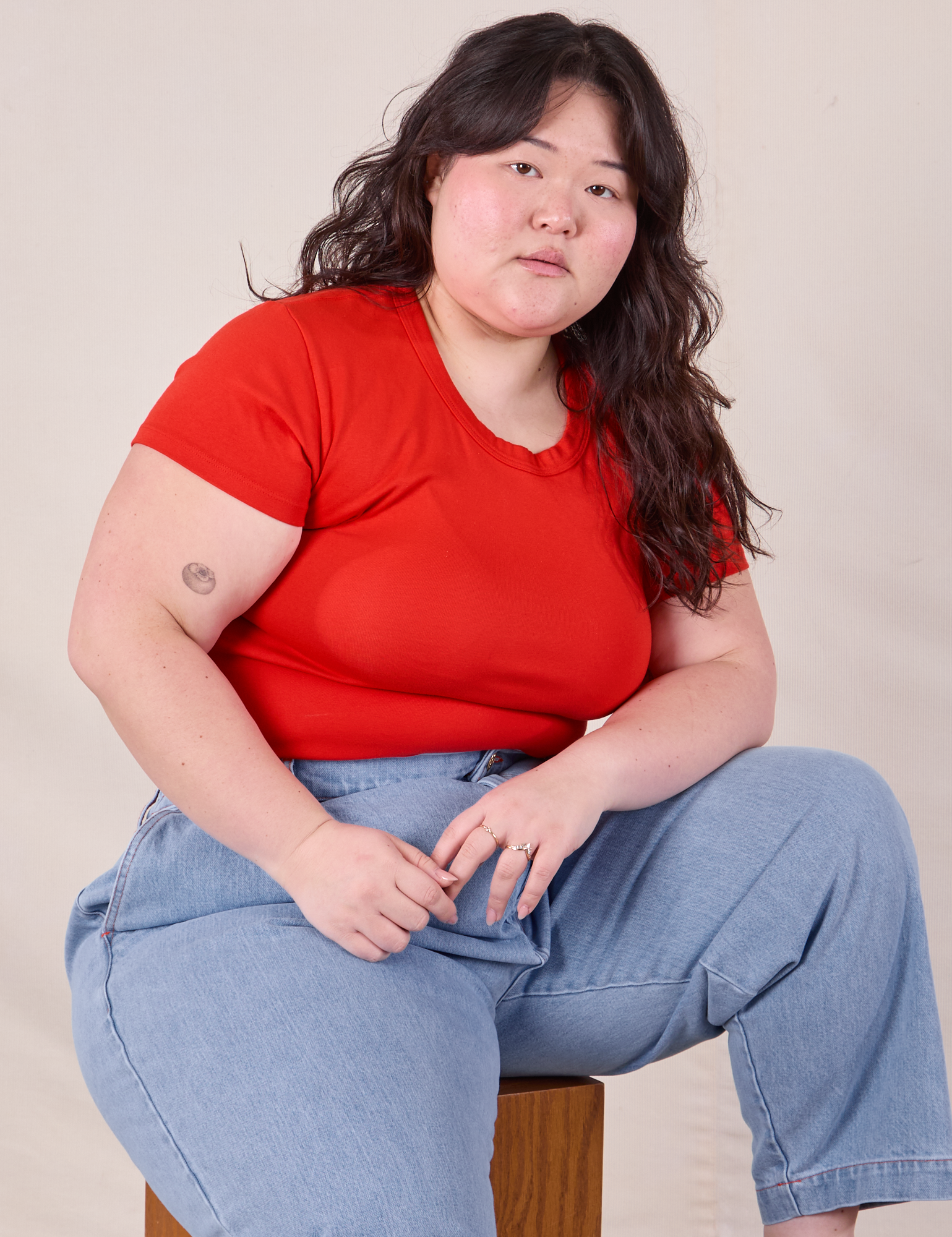 Ashley is wearing Baby Tee in Mustang Red