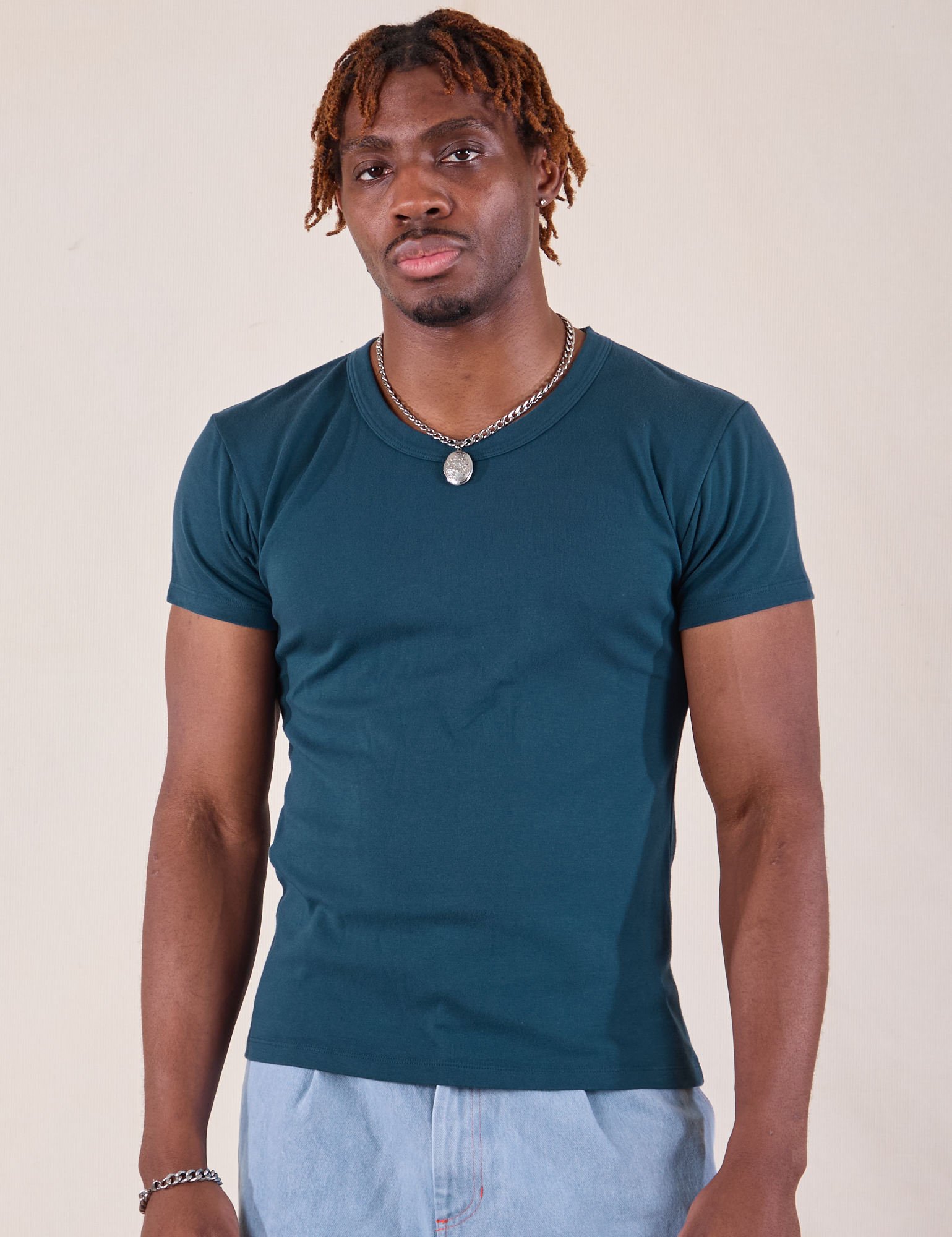 Isaac is 5'10" and wearing L Baby Tee in Lagoon