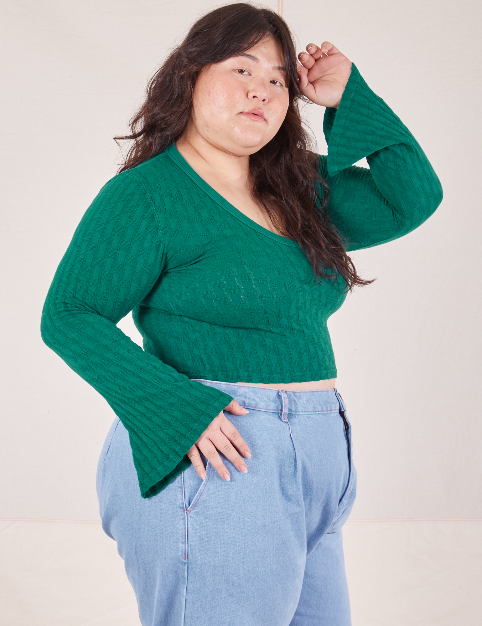 Side view of Bell Sleeve Top in Hunter Green and light wash Trouser Jeans worn by Ashley