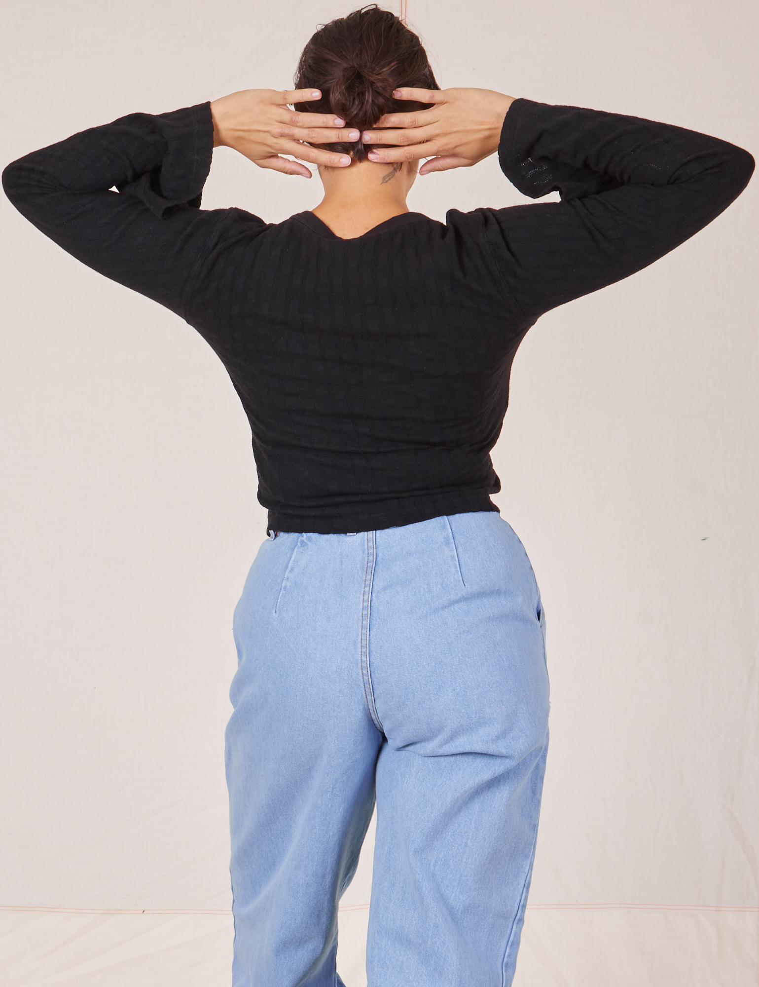 Back view of Bell Sleeve Top in Basic Black and light wash Trouser Jeans worn by Tiara