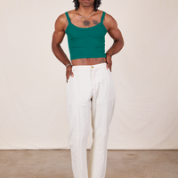 Jerrod is wearing Cropped Cami in Hunter Green and vintage off-white Western Pants
