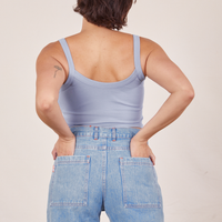 Back view of Cropped Cami in Periwinkle and light wash Sailor Jeans worn by Tiara. She has both hands in the back pant pockets.