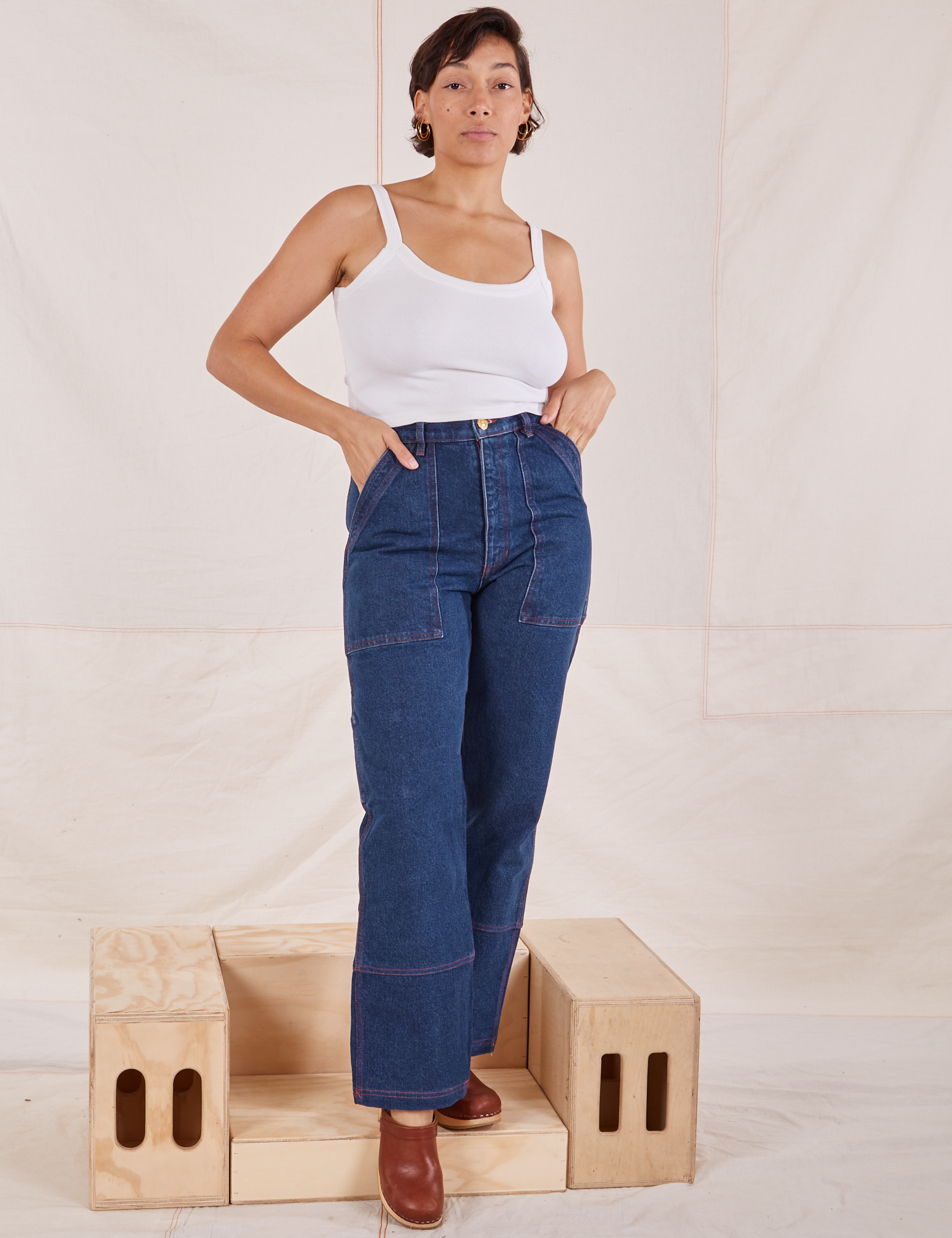 Tiara is wearing Carpenter Jeans in Dark Wash and Cropped Cami in vintage tee off-white