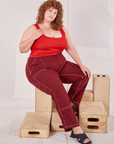 Bree is wearing Railroad Carpenter Jeans in Mustang Red and mustang red Square Neck Tank