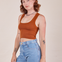 Angled front view of Cropped Tank Top in Burnt Terracotta worn by Alex