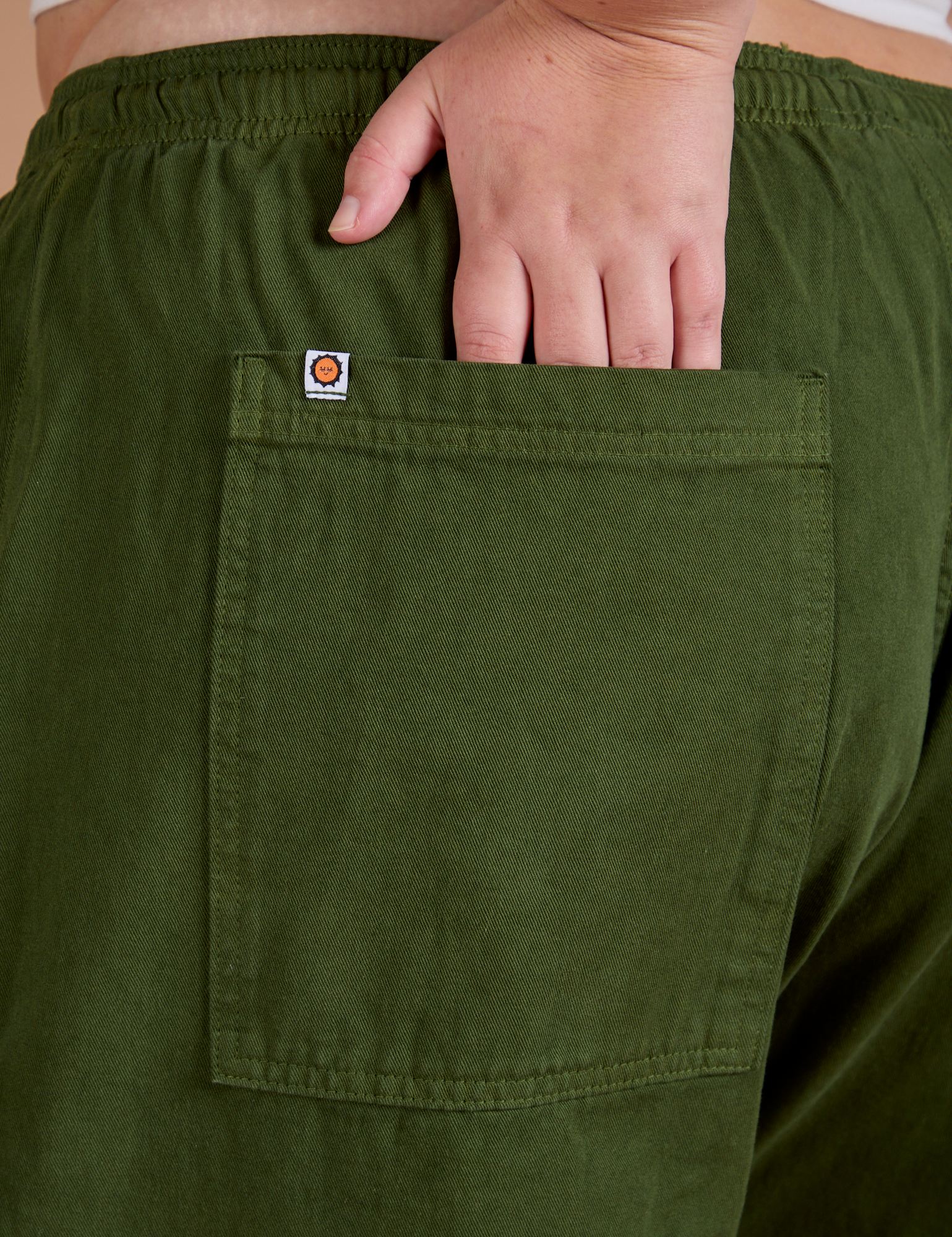 Close up of Juliet's hand tucked into back pocket of Drop Pocket Cargo Pants in Evergreen