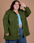 Angled front view of Ripstop Field Coat in Evergreen on Sam