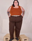 Sam is 5’10” and wearing 4XL Overdyed Denim Trouser in Fudge paired with a Cropped Tank in Burnt Terracotta