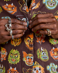 Close up of Jerrod buttoning the Halloween Masks Pantry Button-Up