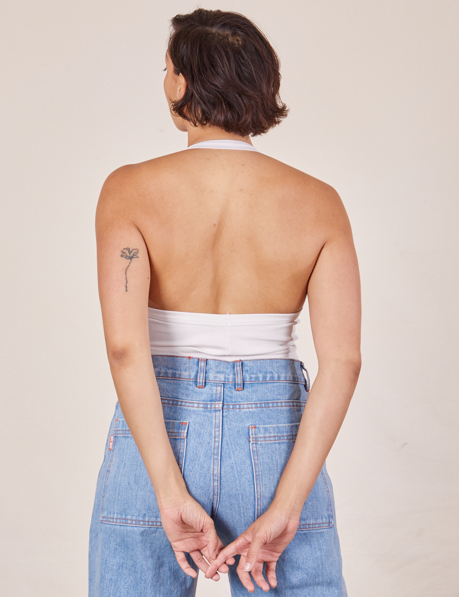 Back view of Halter Top in Vintage Tee Off-White and light wash Sailor Jeans worn by Tiara