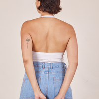 Back view of Halter Top in Vintage Off-White and light wash Sailor Jeans worn by Tiara