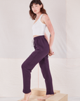 Side view of Rolled Cuff Sweat Pants in Nebula Purple and vintage off-white Cropped Tank Top on Alex