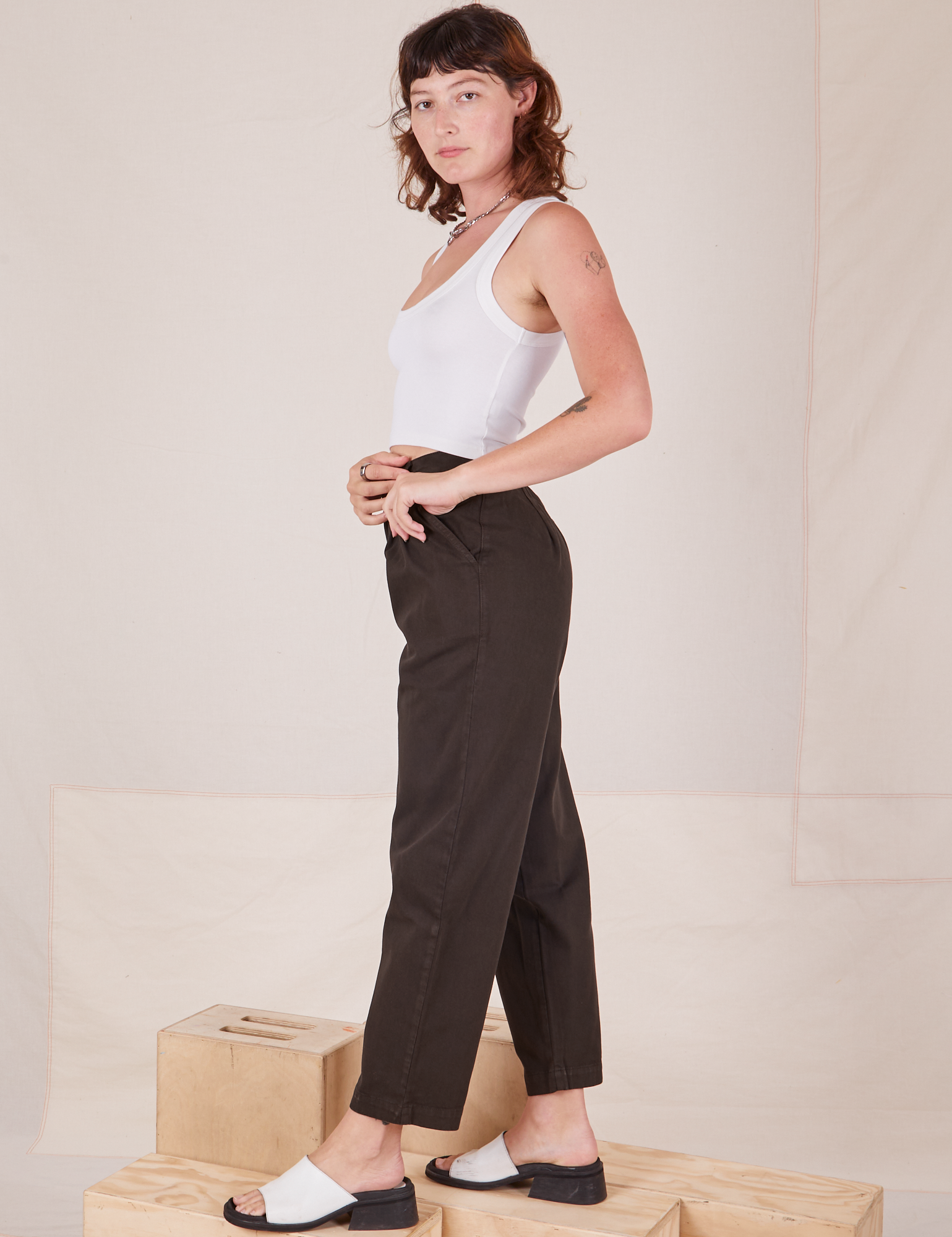 Side view of Heavyweight Trousers in Espresso Brown and Cropped Tank Top in vintage tee off-white worn by Alex