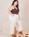 Side view of Heavyweight Trousers in Vintage Tee Off-White and espresso brown Cropped Cami worn by Ashley