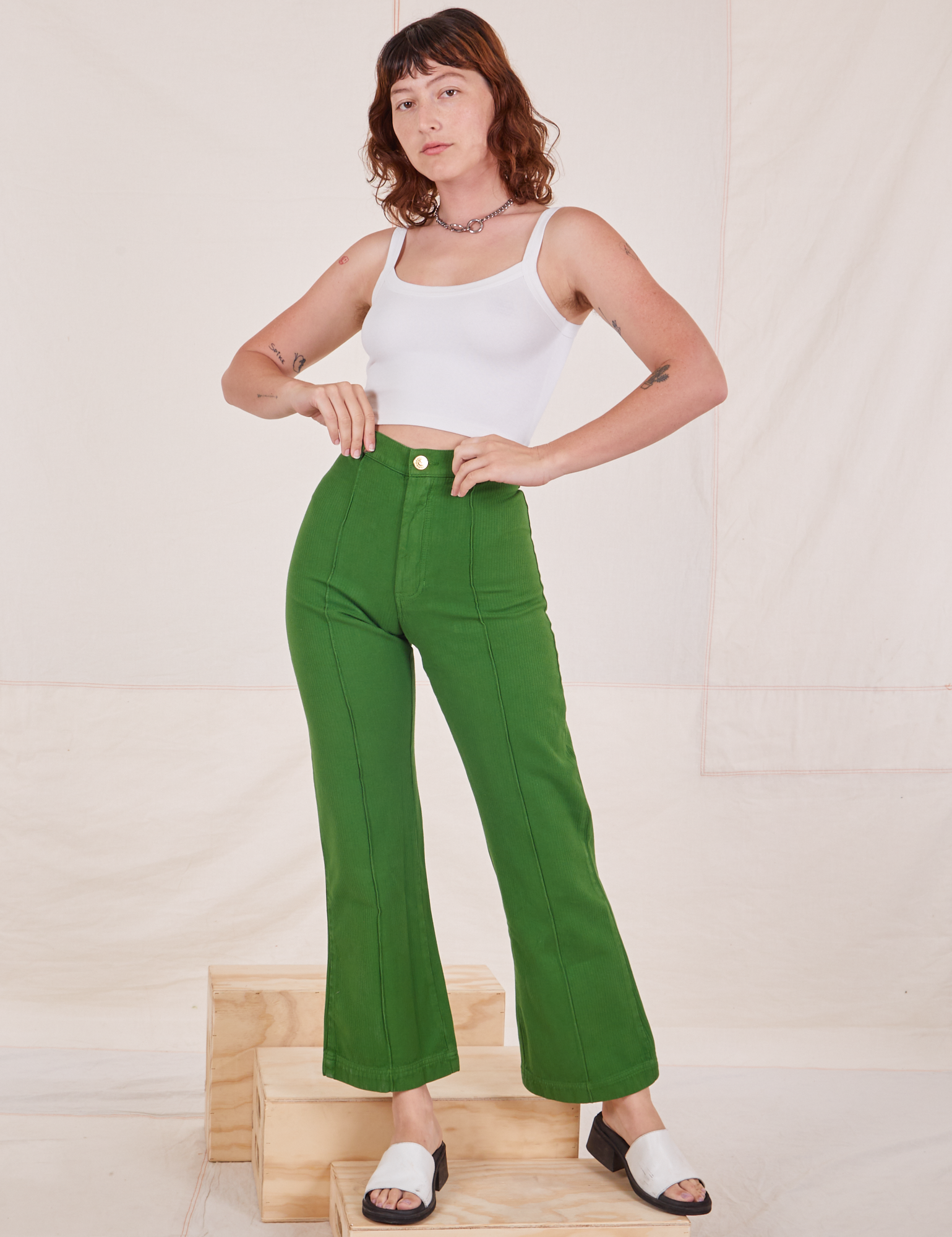 Alex is 5&#39;8&quot; and wearing XS Heritage Westerns in Lawn Green paired with Cropped Cami in vintage tee off-white