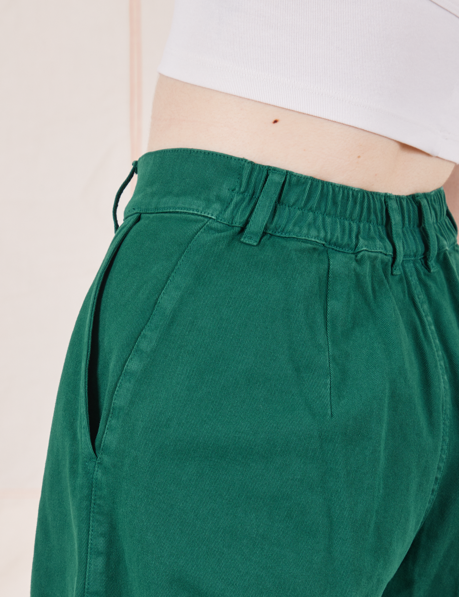 Back close up of elastic waistband of Heavyweight Trousers in Hunter Green on Hana