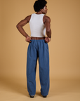 Back view of Baggy Mid-Rise Trousers in French Blue and vintage tee white Cropped Tank on Jerrod