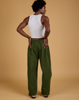 Back view of Baggy Mid-Rise Trousers in Evergreen and vintage tee white Cropped Tank on Jerrod