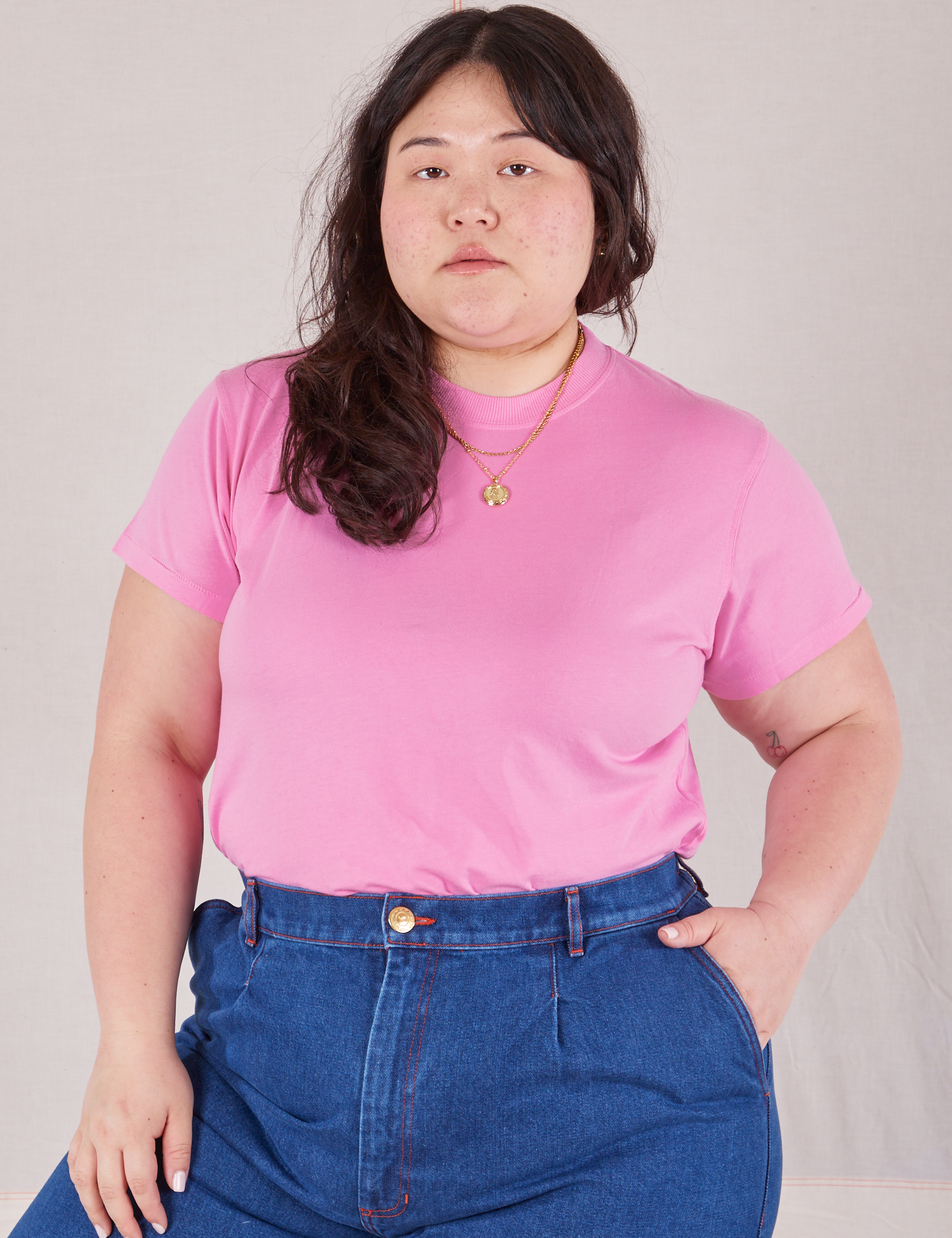 Ashley is wearing Organic Vintage Tee in Bubblegum Pink tucked into dark wash Trouser Jeans