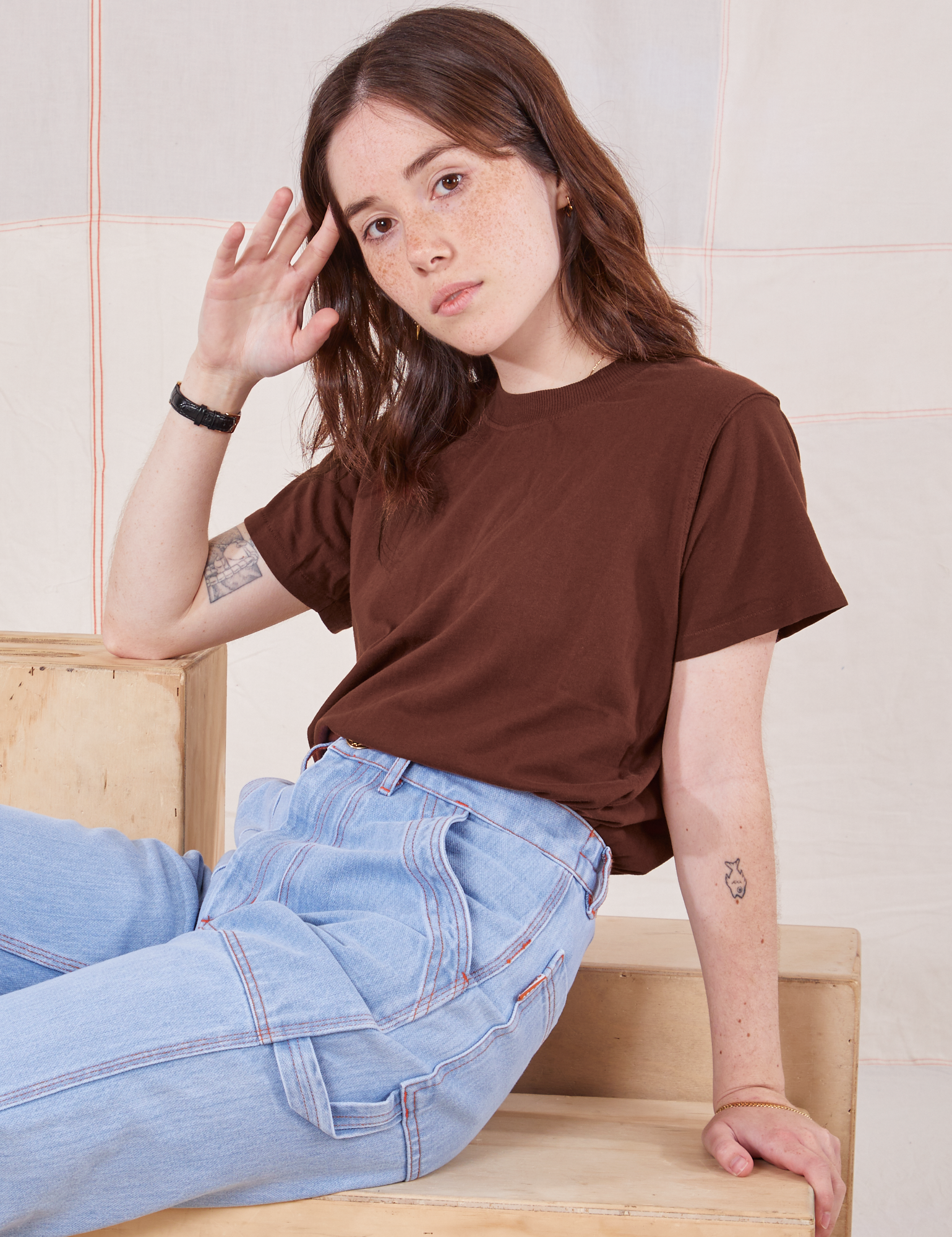 Hana is wearing Organic Vintage Tee in Fudgesicle Brown and light wash Carpenter Jeans
