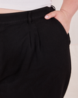 Front close up of Organic Trousers in Basic Black. Ashley has her hand in the pocket.