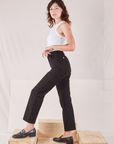Side view of Organic Work Pants in Basic Black and Racerback Tank in vintage tee off-white on Alex