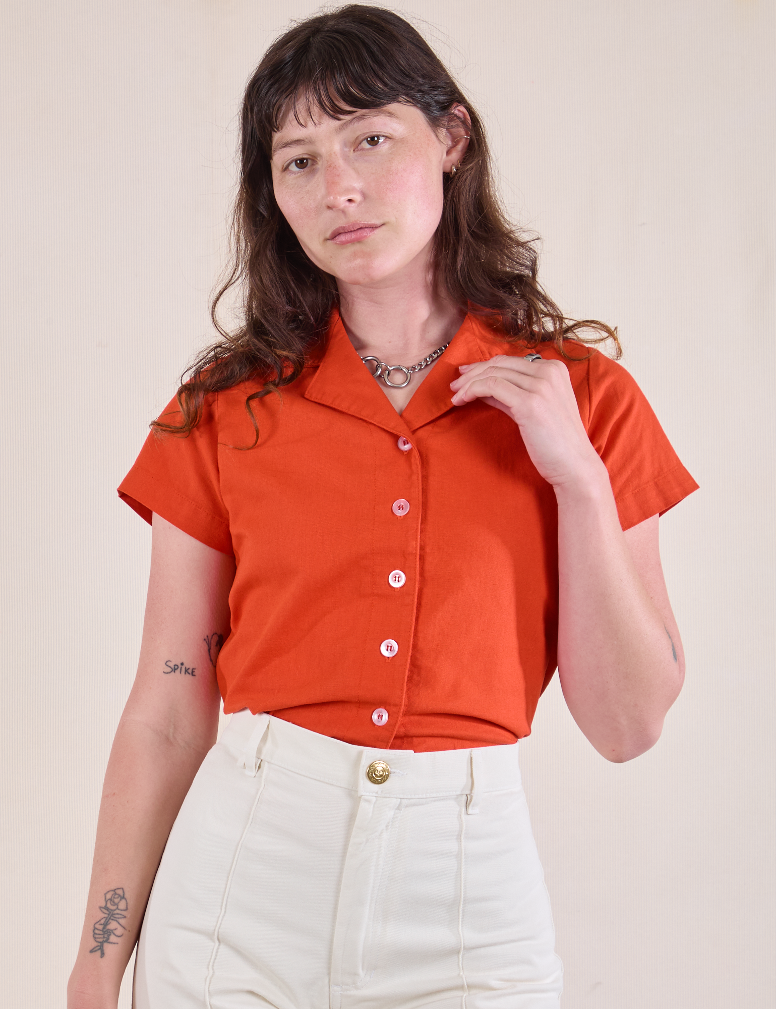 Alex is wearing Pantry Button-Up in Chili Red tucked into vintage tee off-white Western Pants
