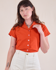 Alex is wearing Pantry Button-Up in Chili Red tucked into vintage tee off-white Western Pants