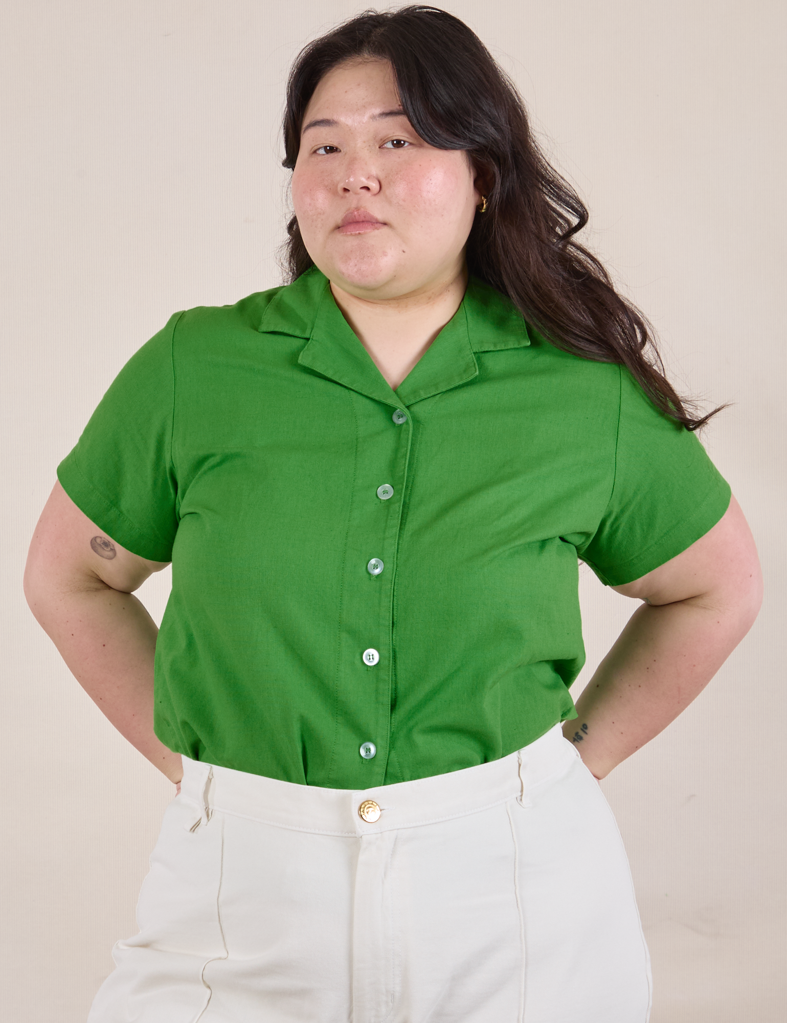 Ashley is wearing Pantry Button-Up in Kelly Green tucked into vintage tee off-white Western Pants