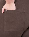 Pencil Pants in Espresso Brown back pocket close up. Marielena has her hand in the pocket.