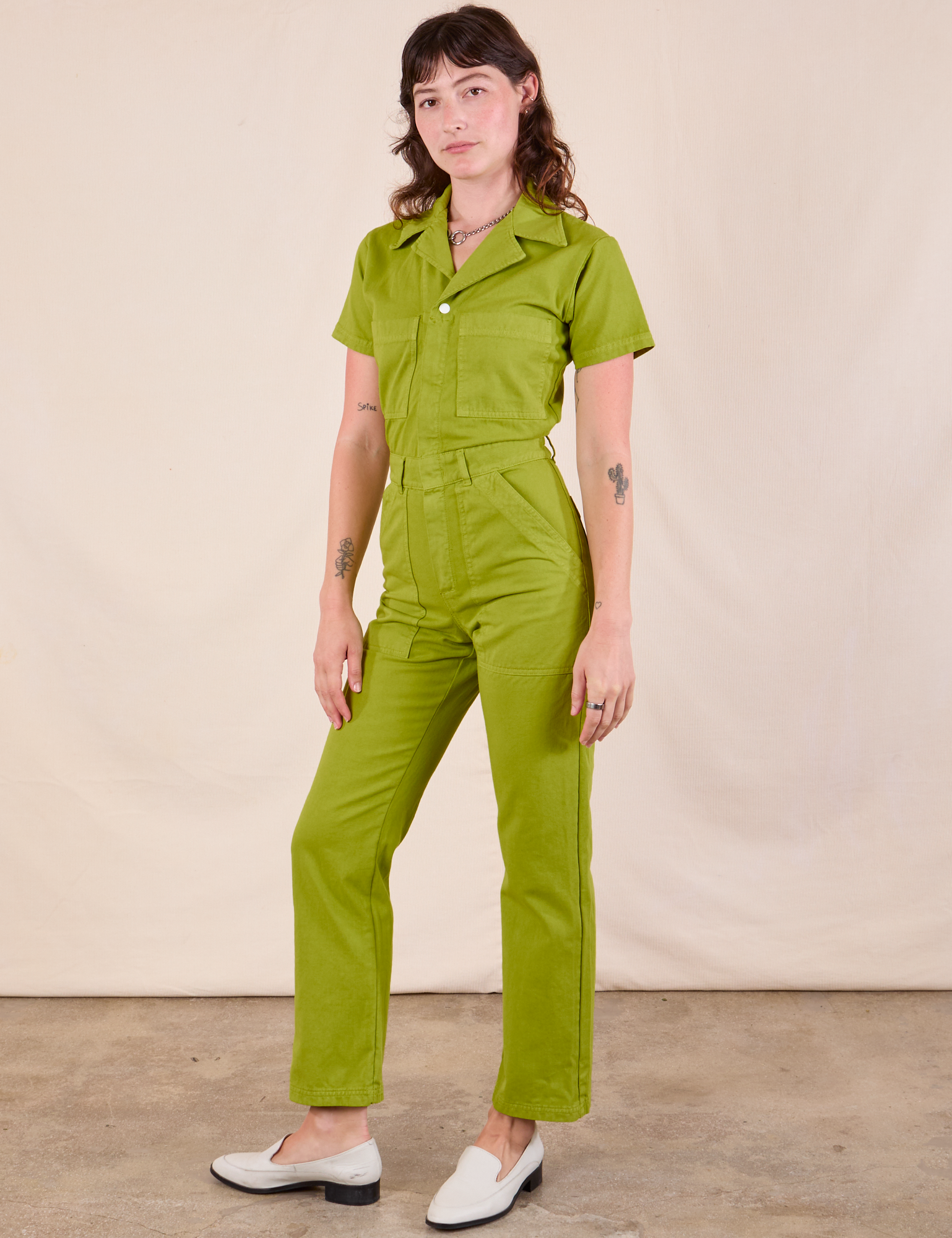 Short Sleeve Jumpsuit in Gross Green angled front view on Alex