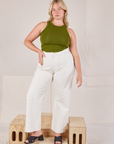 Lish is wearing Racerback Tank in Summer Olive and Western Pants in vintage tee off-white