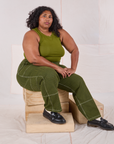 Morgan is wearing Railroad Carpenter Jeans in Summer Olive and summer olive Muscle Tee