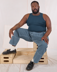 Elijah is wearing Railroad Carpenter Jeans in Baby Blue and marine blue Muscle Tee