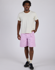 Isaac is 5’10” and wearing M Longline Work Shorts in Lilac Purple paired with vintage tee white Burly Tee