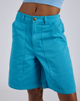 Longline Work Shorts in Hawaiian Blue front close up on Kira