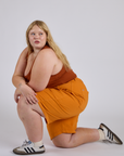 Longline Work Shorts in Creamsicle Orange and burnt terracotta Cropped Tank worn by Juliet
