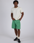 Isaac is 5’10” and wearing M Longline Work Shorts in Seafoam Green paired with Burly Tee in Vintage Tee White