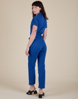 Angled back view of Short Sleeve Jumpsuit in Royal Blue on Alex